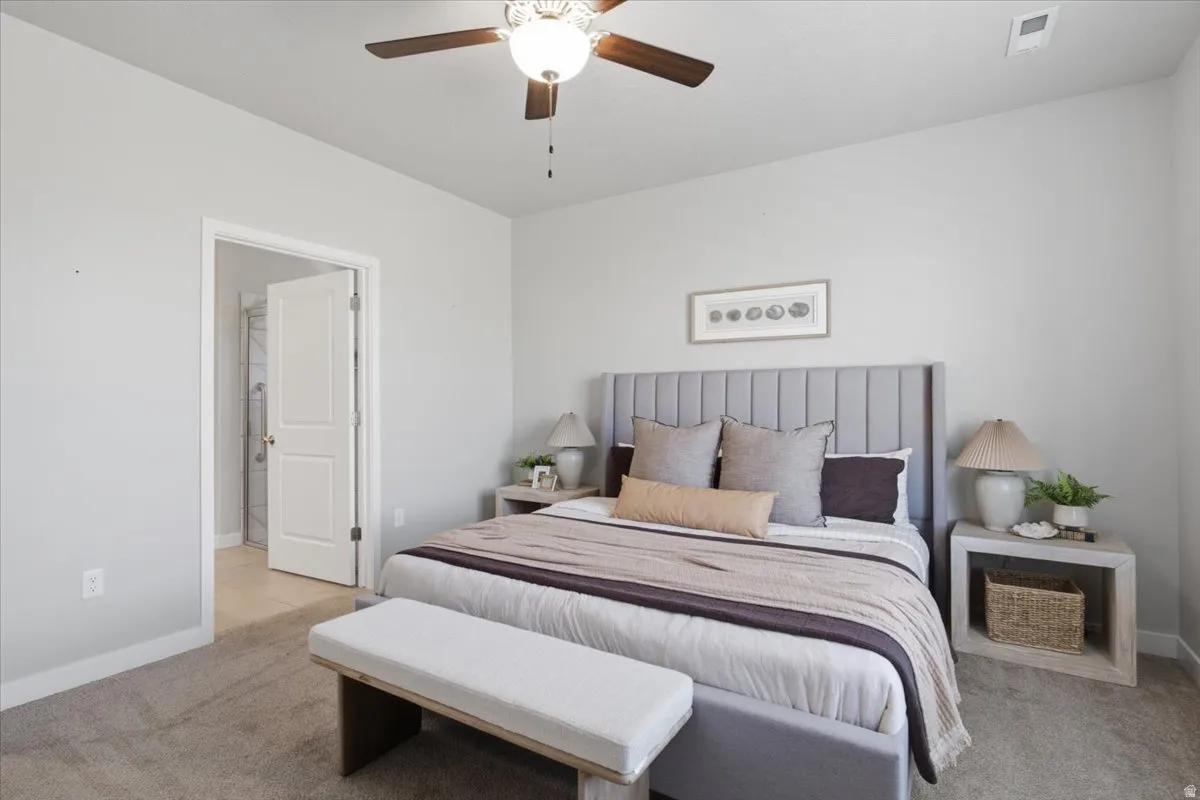 Carpeted bedroom with a paneled headboard