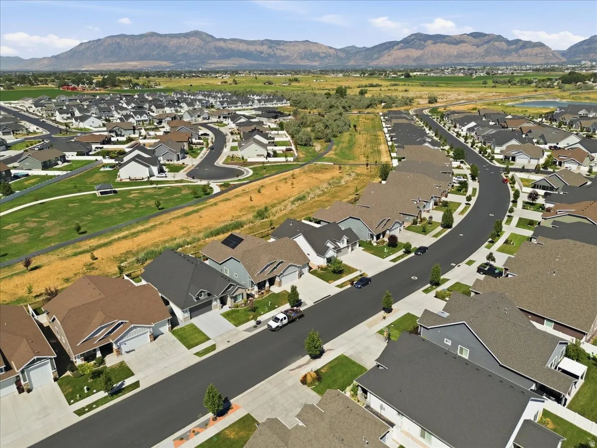 Aerial perspective showcasing a developed residential community with diverse home exteriors, curvilinear streets, and verdant open spaces