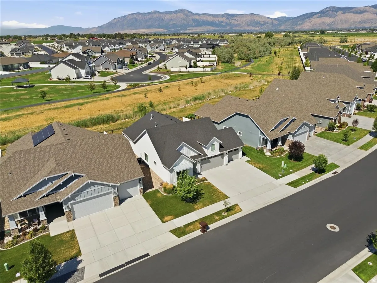 Modern residential community with contemporary homes featuring varied rooflines, paved driveways, and manicured lawns