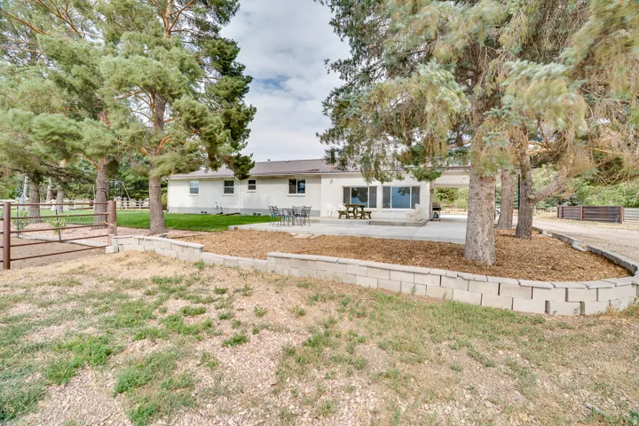 Charming single-story residence situated on expansive grounds featuring mature trees and open lawn space