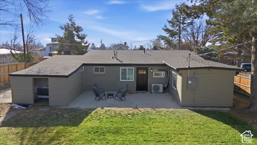 Rear exterior with an open patio area, surrounded by a gravel surface