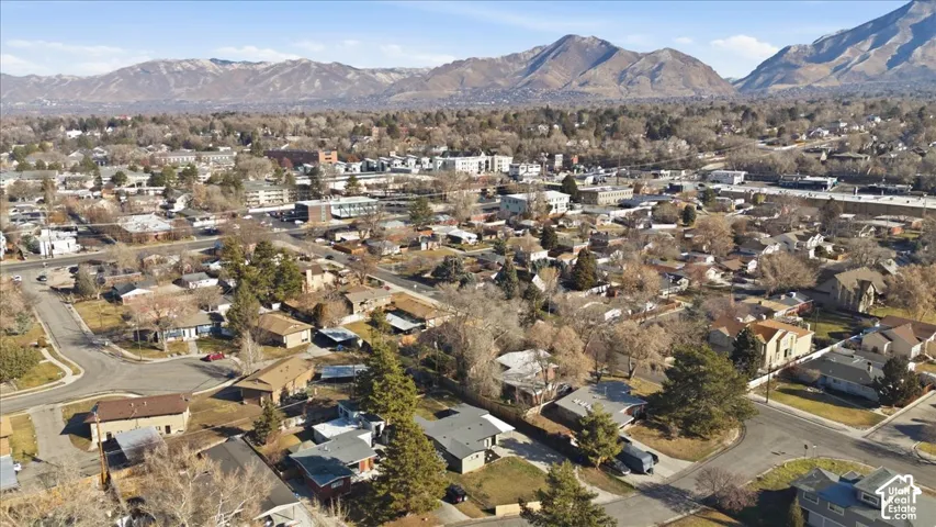 Neighborhood aerial showcasing residential properties with a mountainous backdrop