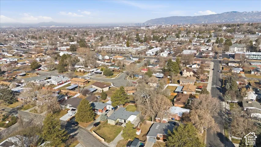 Expansive aerial view of a residential neighborhood with a variety of single-family homes and mature trees