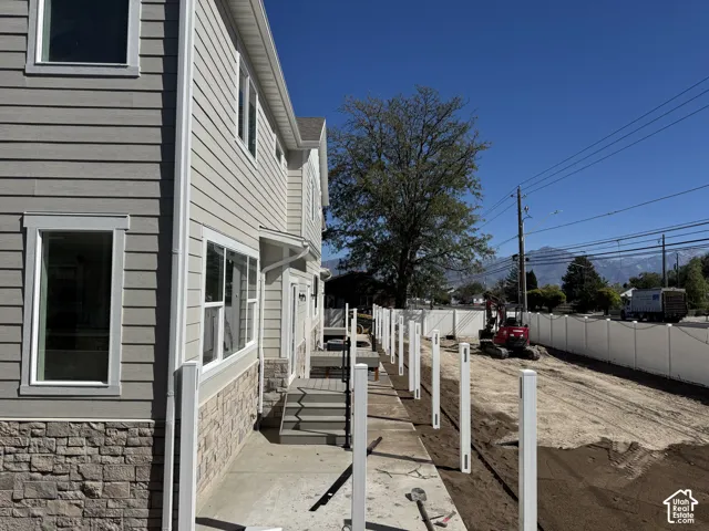 Two-story exterior with horizontal siding and stone veneer accent