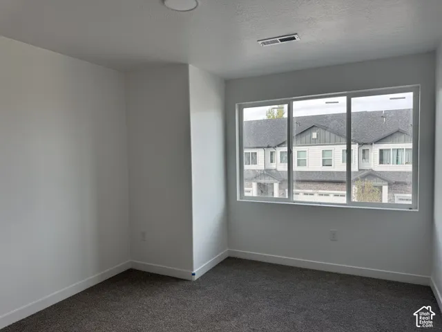 Wall-to-wall carpeting, white painted walls, and a recessed ceiling light fixture