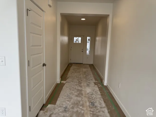 Recessed lighting illuminates the entry hall