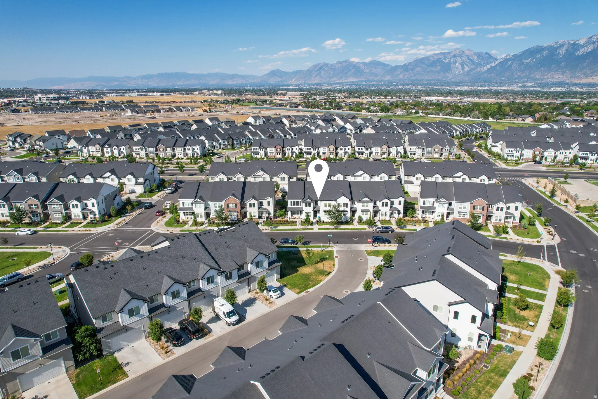 Aerial perspective featuring a community of contemporary townhomes and single-family residences