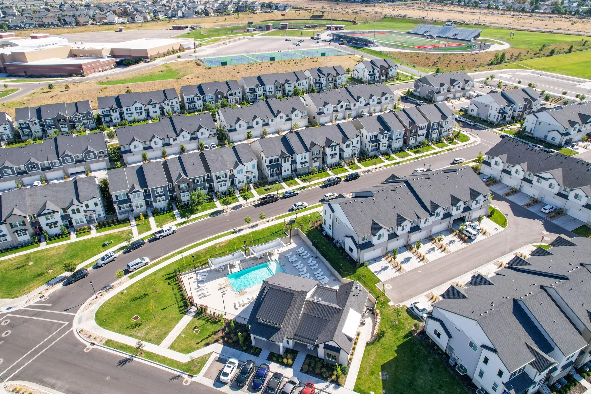 Aerial view showcasing a community with multiple residential buildings and a central amenity area