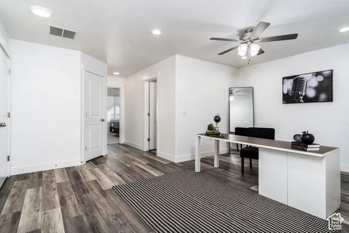 Open room featuring wood-finish flooring, recessed lighting, and a ceiling fan with integrated lighting