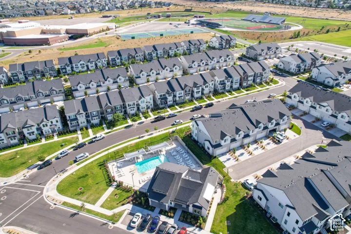 Aerial view showcasing a community with multiple residential buildings and a central amenity area