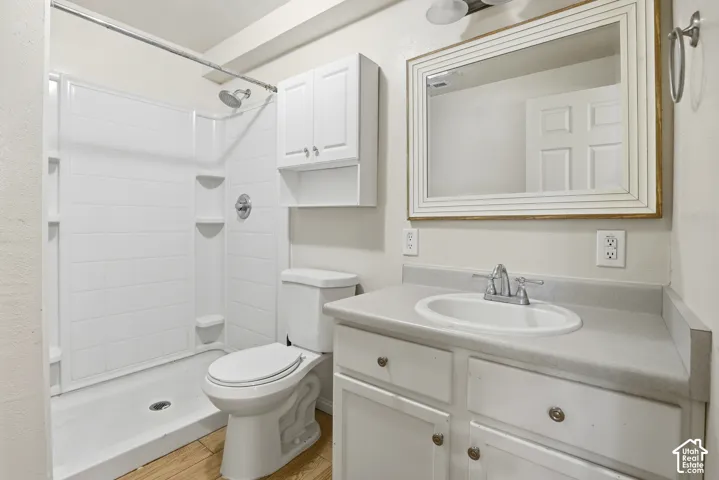 White vanity with silver hardware, an integrated sink, and a framed mirror