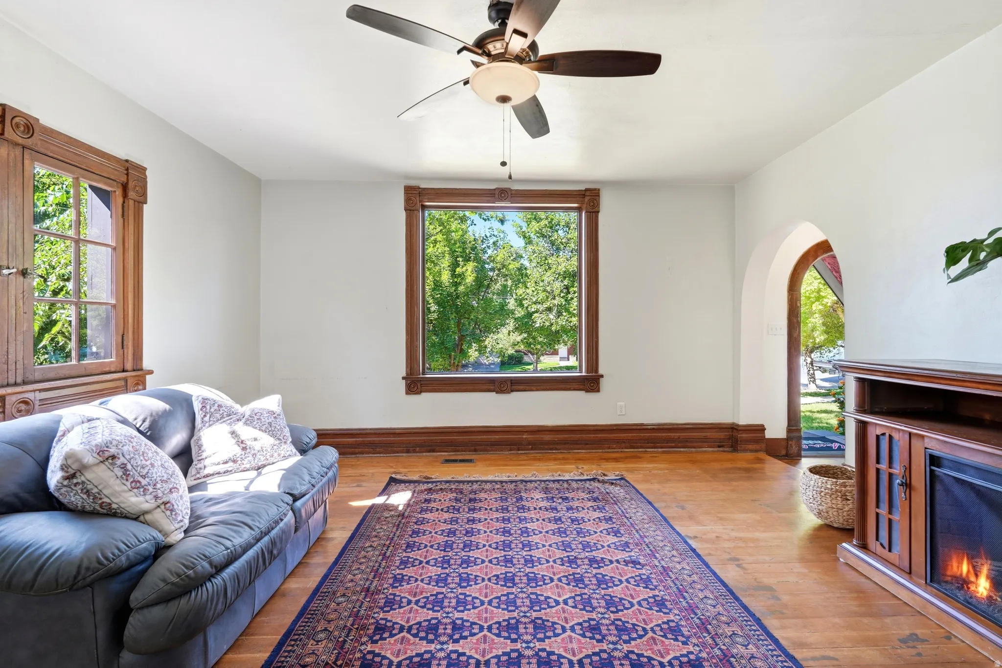 Hardwood flooring throughout featuring ornate wood trim and baseboards