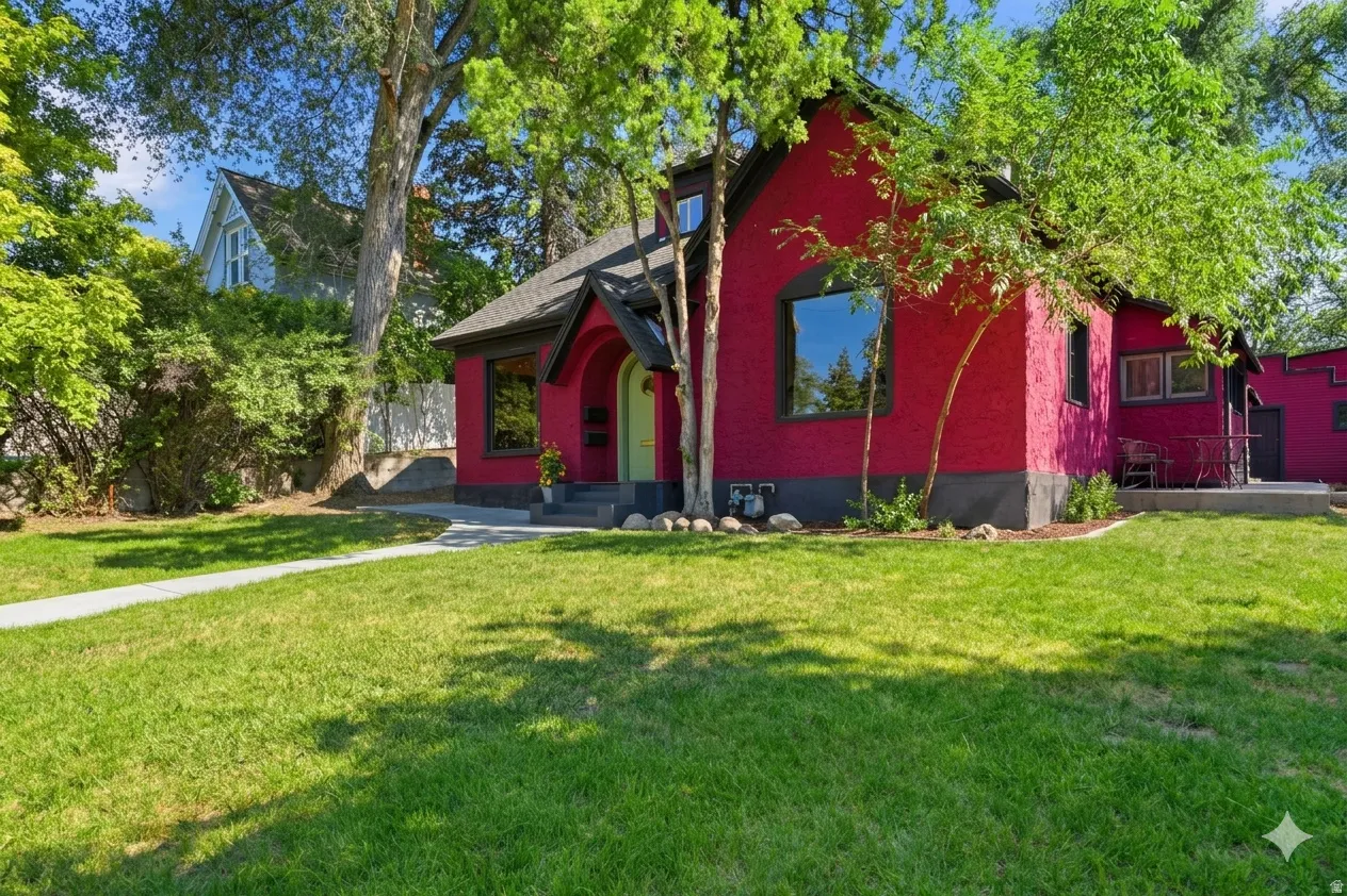 Vibrant crimson exterior featuring a dark trim and arched window