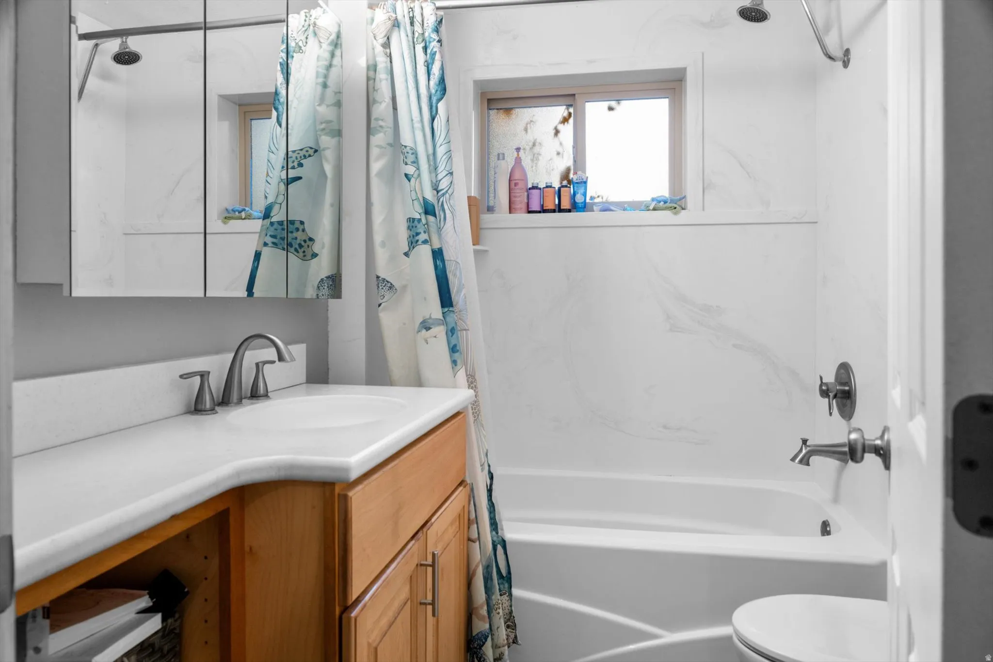 Bathroom featuring a built-in bathtub with a tile-look surround and brushed nickel fixtures