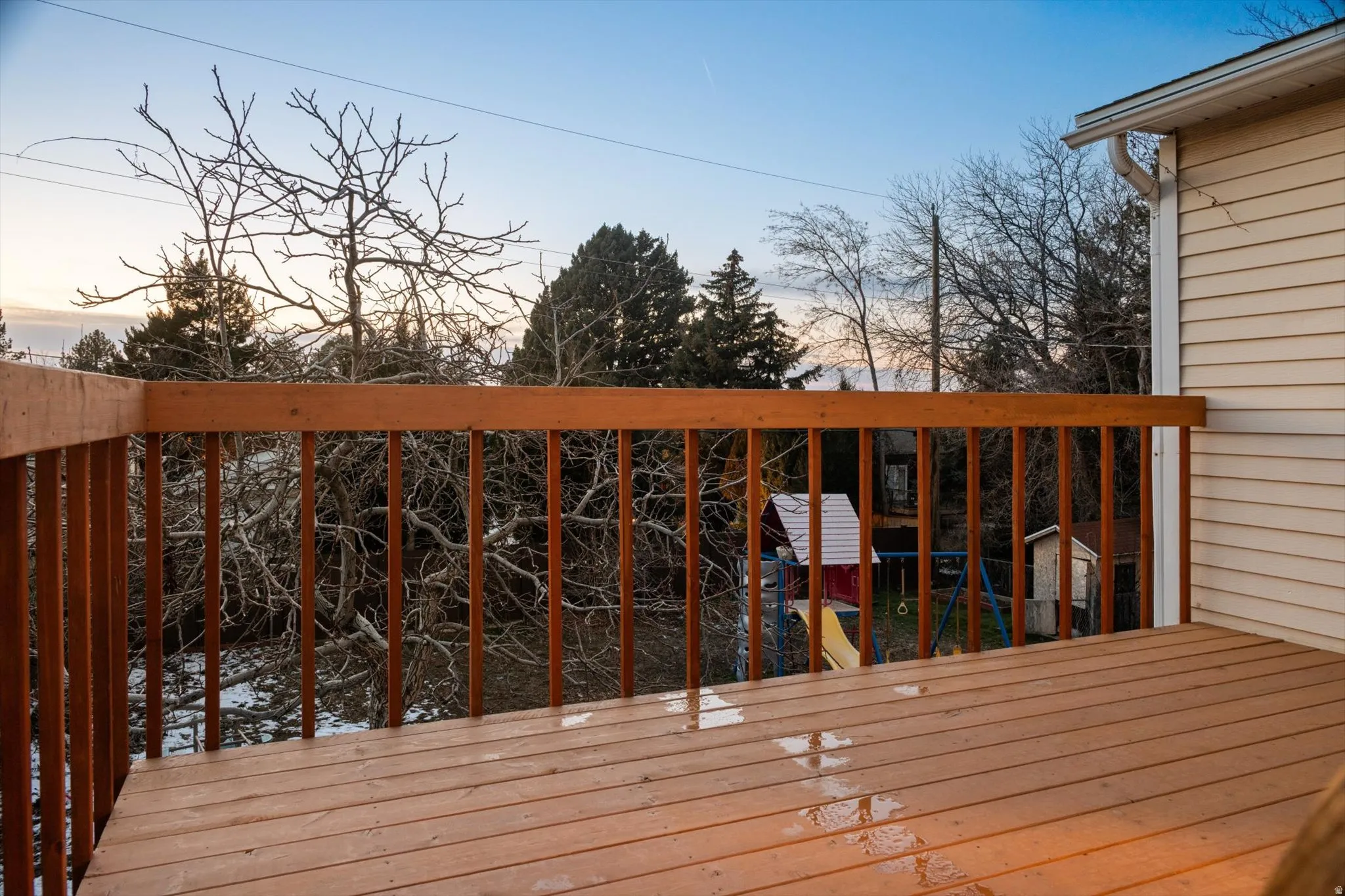Upper-level deck featuring wood-finish flooring and railing