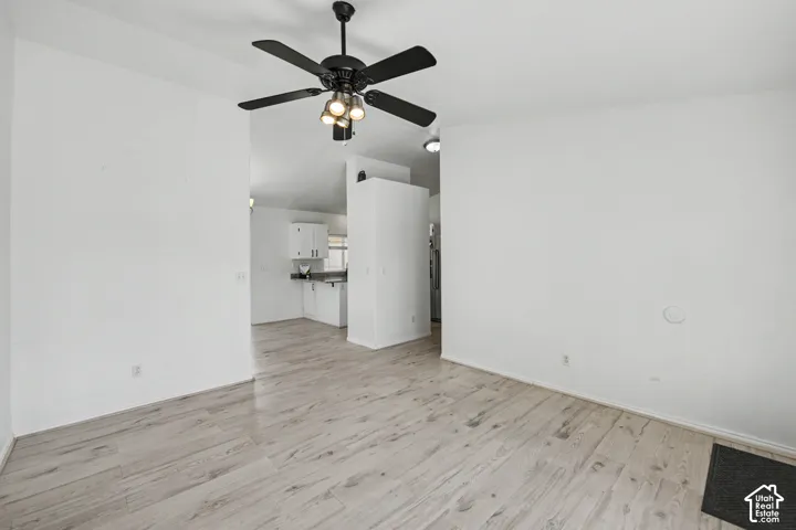 Wood-finish flooring, recessed lighting, and a ceiling fan with integrated lighting