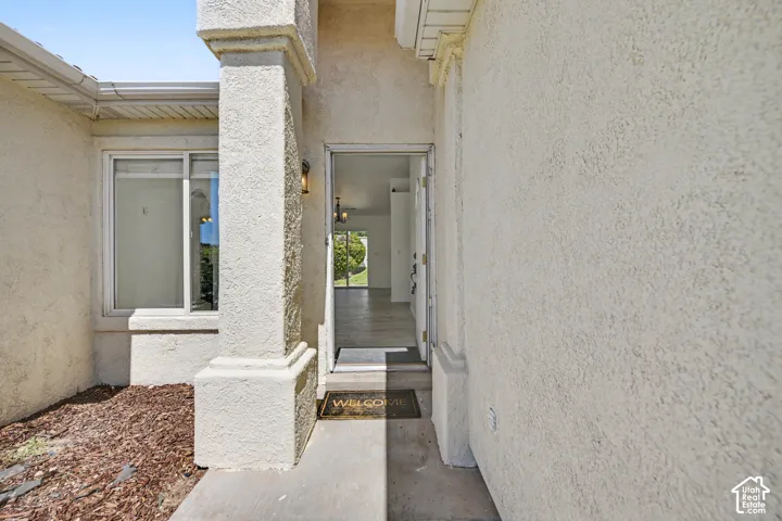 Stucco exterior with a prominent entrance pillar and a recessed doorway