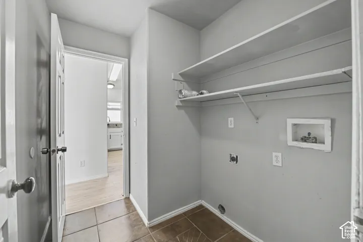 Built-in shelving, tile flooring, and utility hookups