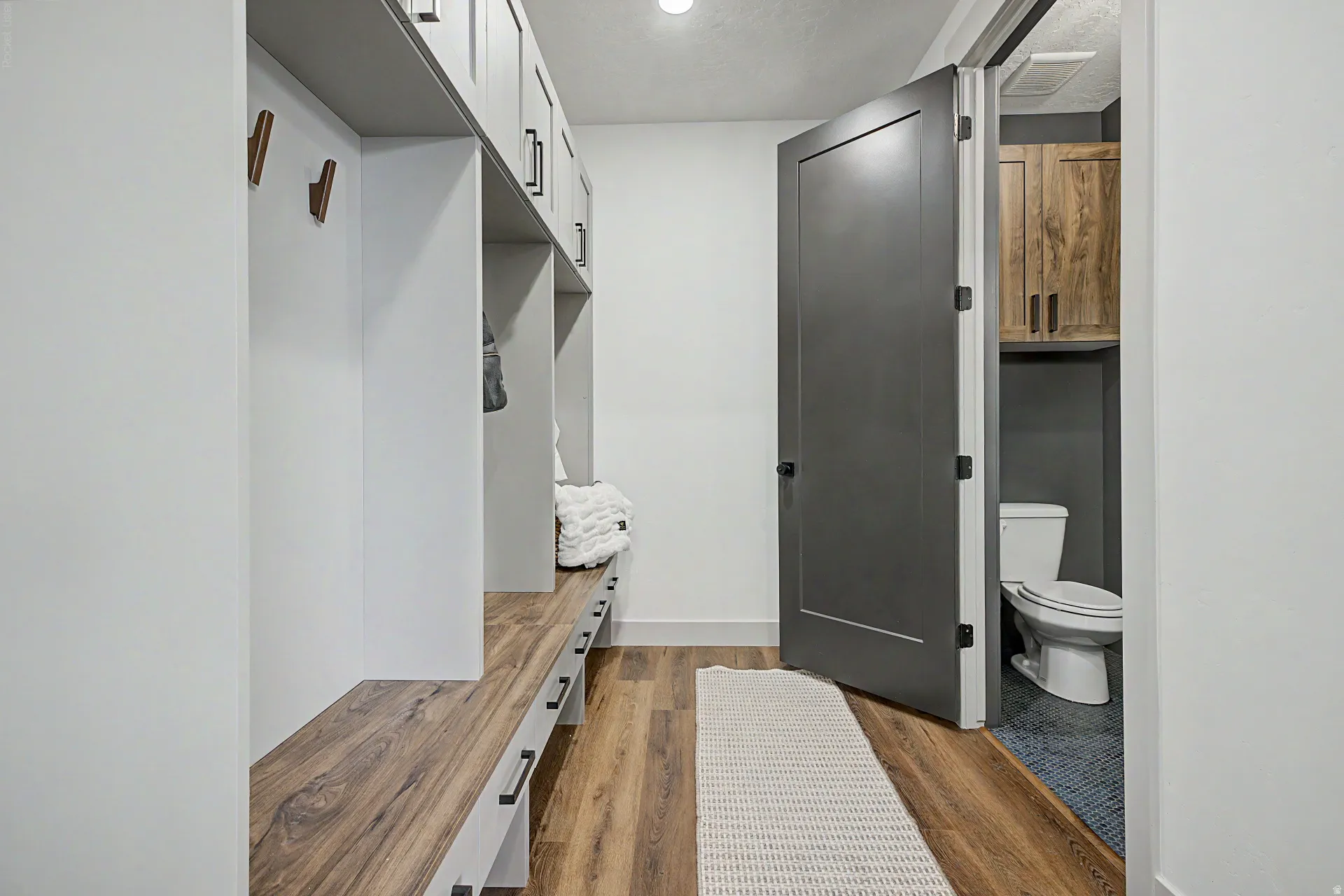 Entryway with built-in cubbies and wood-finish bench seating