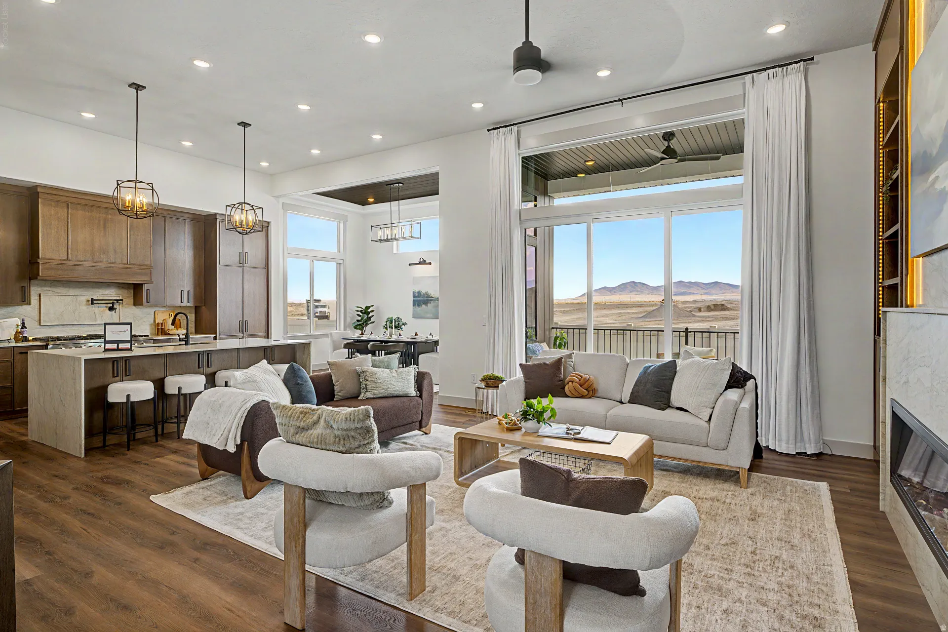 Open-concept living area featuring wood-finish flooring, a contemporary fireplace, and recessed lighting