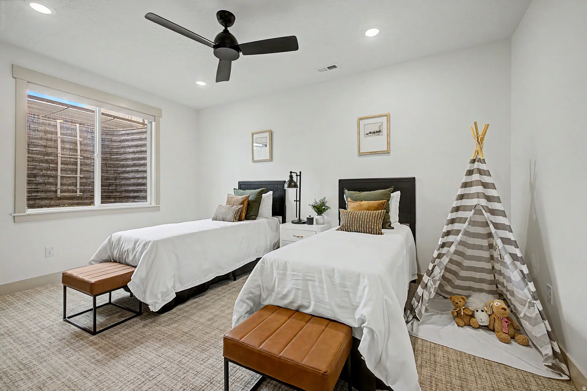 Spacious room featuring a large egress window, patterned carpet flooring, a ceiling fan, and recessed lighting