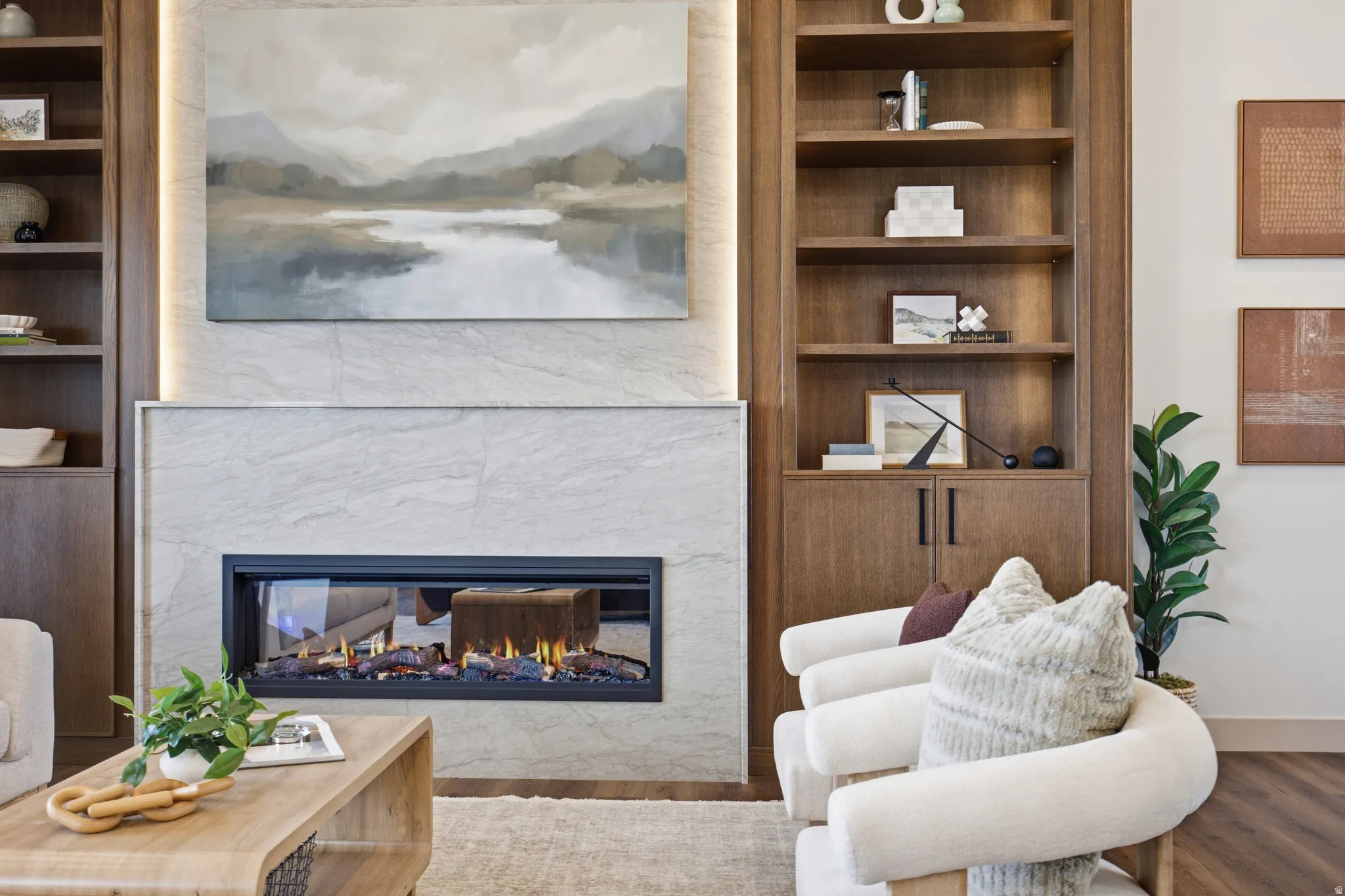 Modern fireplace featuring a wide horizontal firebox, stone surround, and integrated accent lighting
