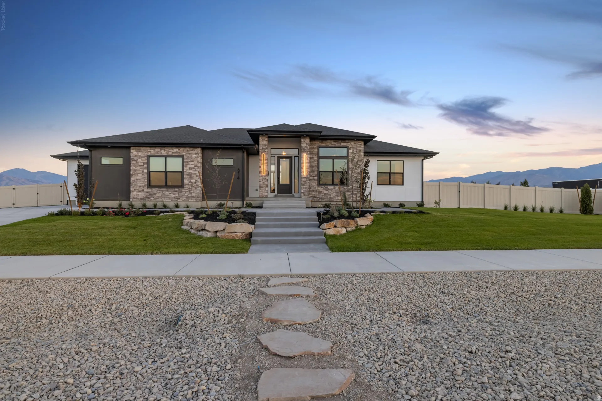 Contemporary single-story residence featuring a stone and stucco facade