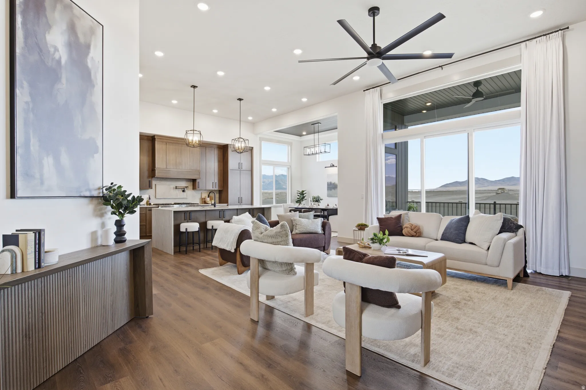 Open-concept living area featuring wood-finish flooring, recessed lighting, and a modern ceiling fan