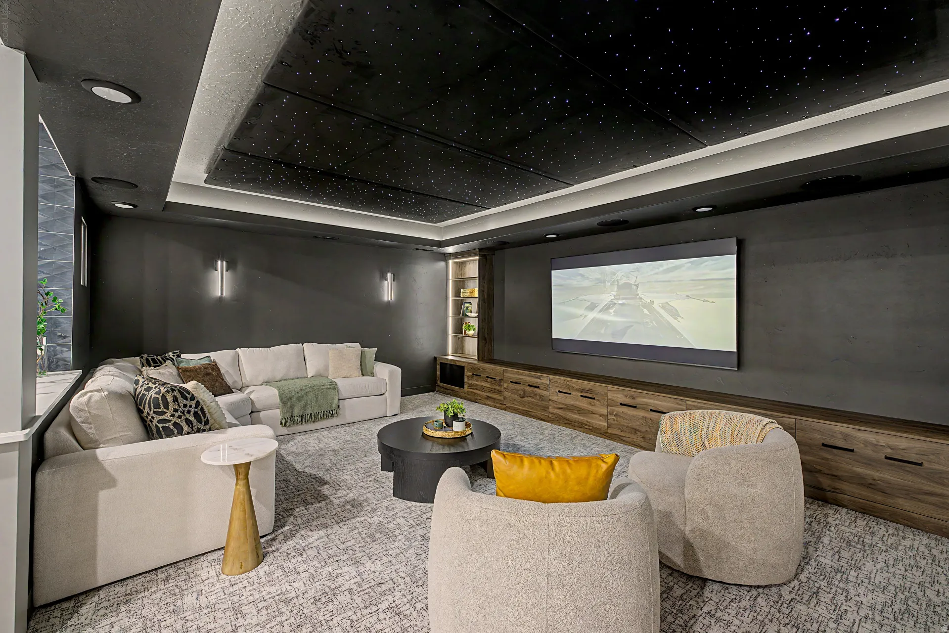 Dedicated media room featuring a starry fiber optic ceiling, recessed lighting, and a large wall-mounted screen