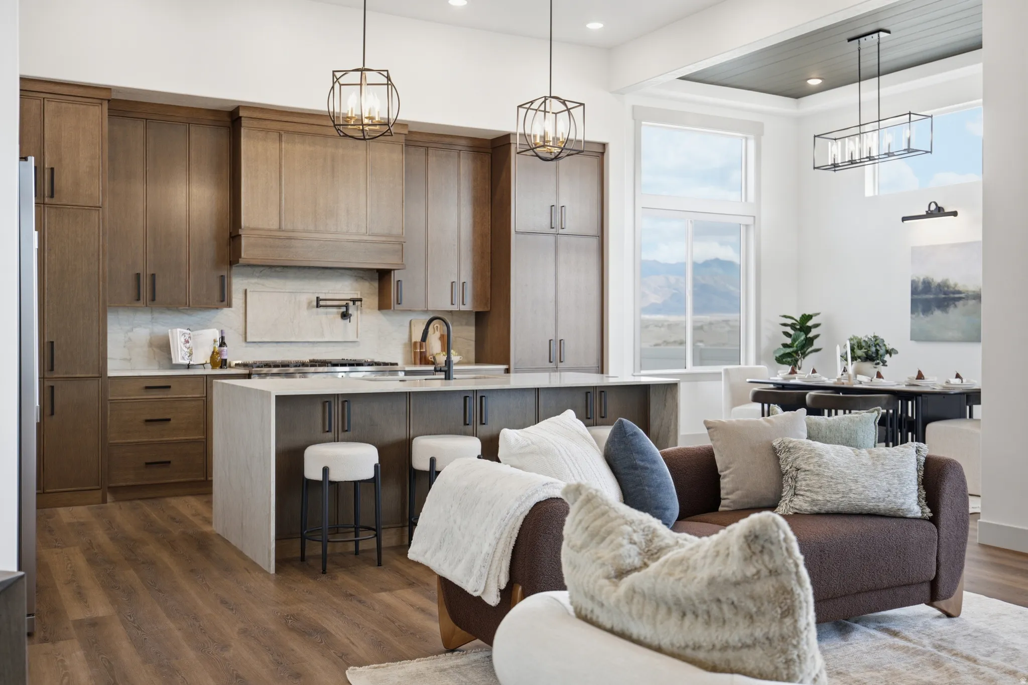 Gourmet kitchen featuring wood-finish cabinetry, a large center island, and integrated appliances