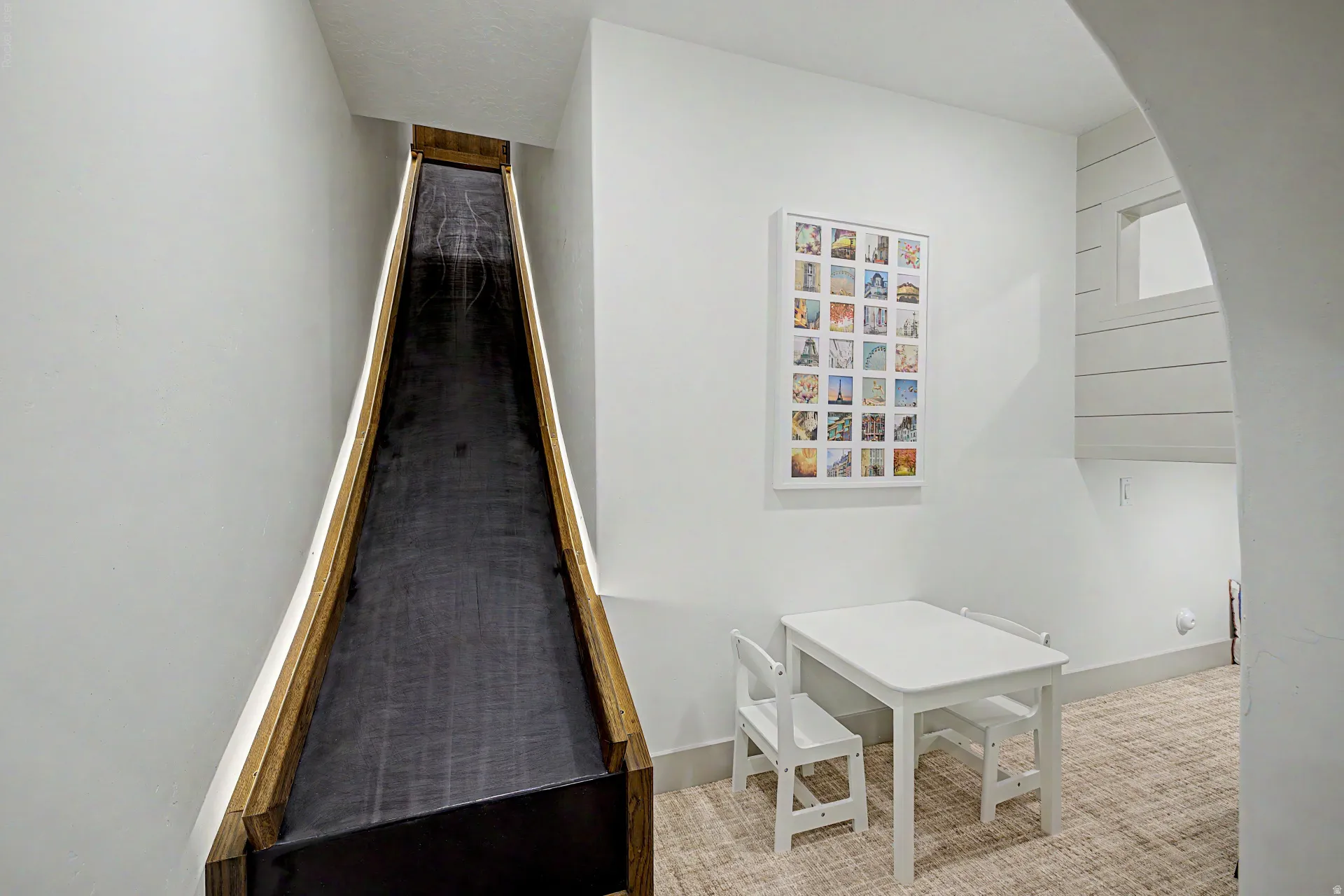 Built-in indoor slide with natural wood-tone side rails