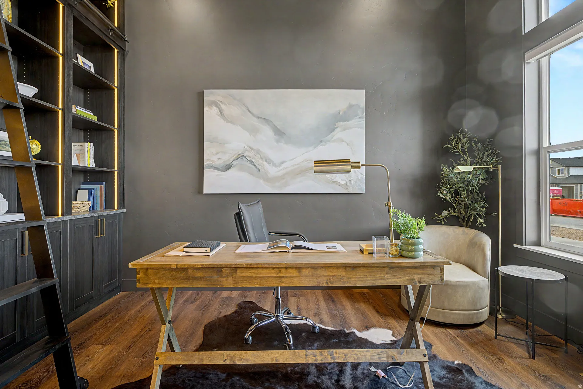 Dedicated space featuring rich wood-finish flooring and dark wall finishes