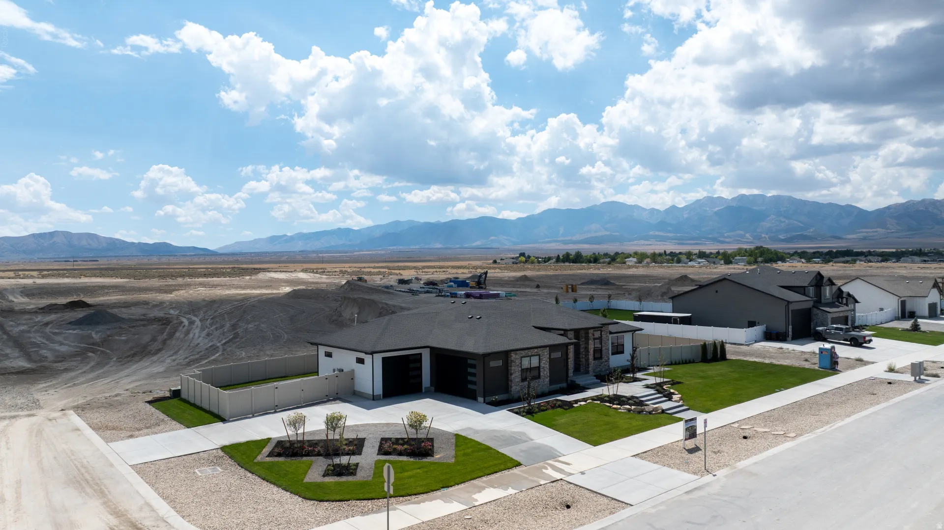 Modern single-story residence featuring a dark roof and a light exterior facade