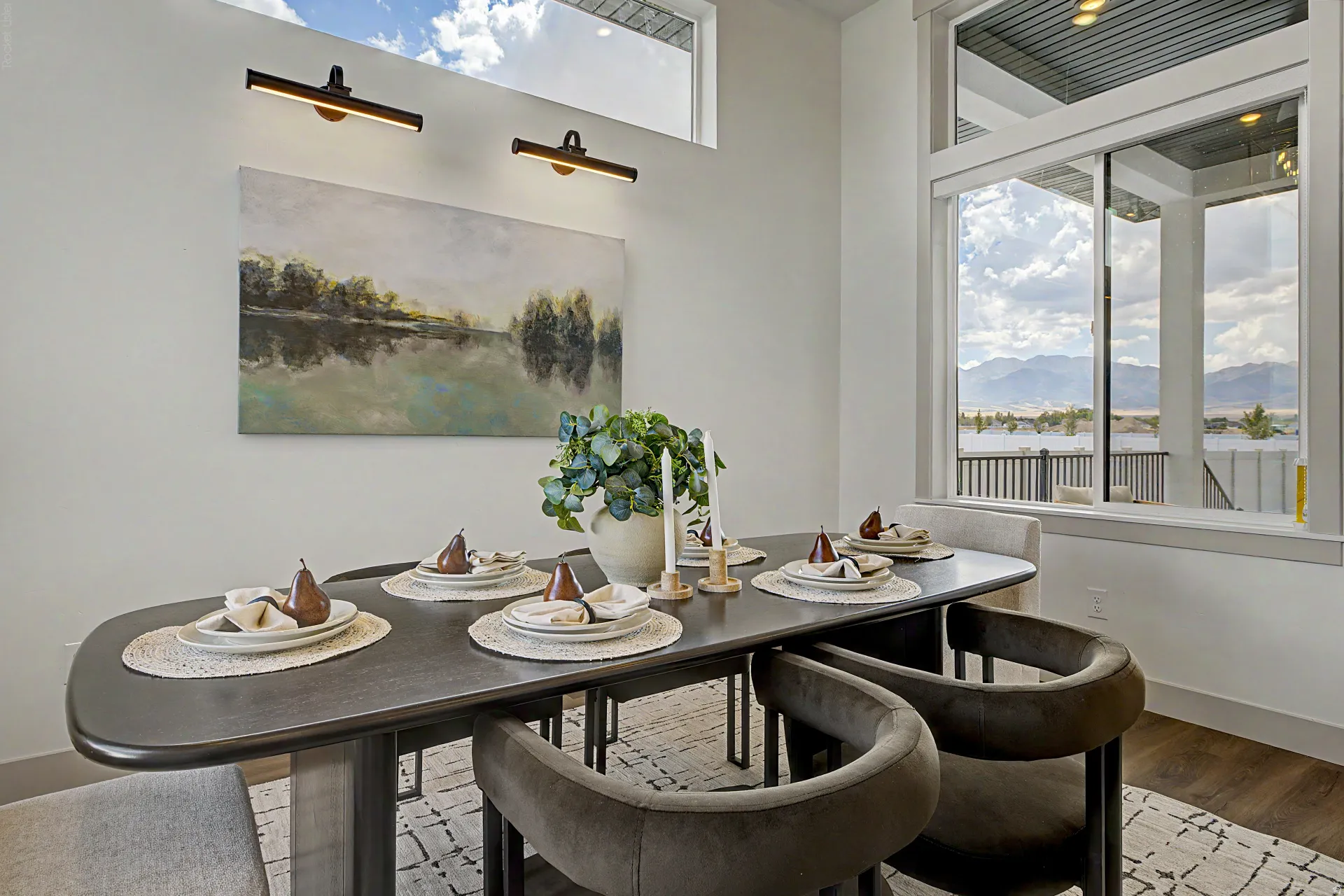 Dining area featuring a large window with mountain scenery, a rectangular transom window, and wood-finish flooring