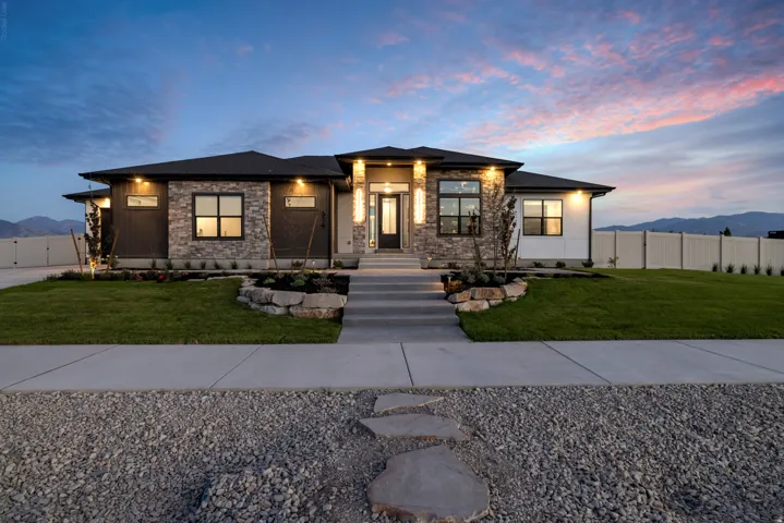 Contemporary single-story residence with stone and siding exterior