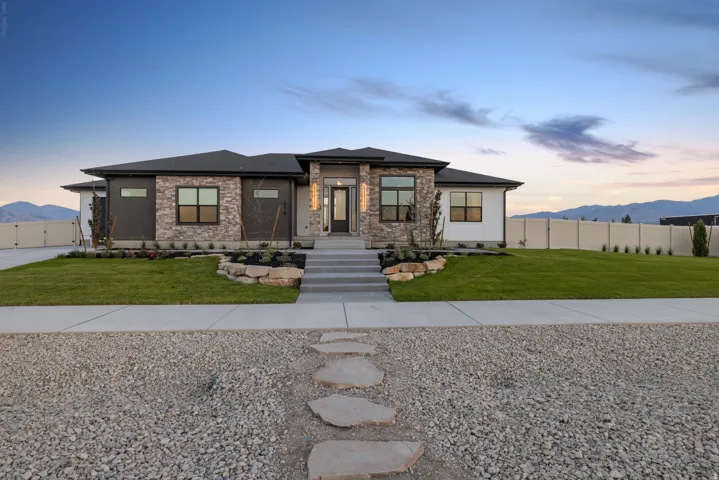 Contemporary single-story residence featuring a stone and stucco facade