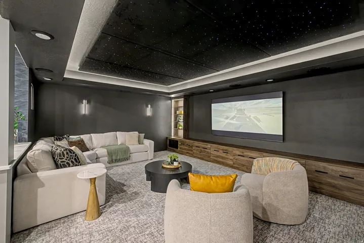 Dedicated media room featuring a starry fiber optic ceiling, recessed lighting, and a large wall-mounted screen