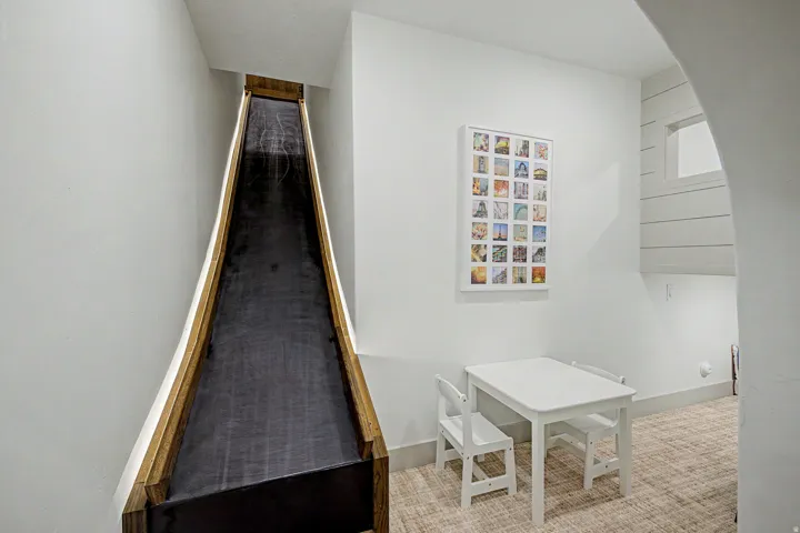 Built-in indoor slide with natural wood-tone side rails