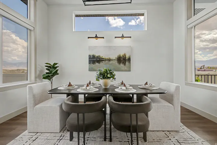 Dining area featuring wood-finish flooring, white baseboards, and a contemporary light fixture