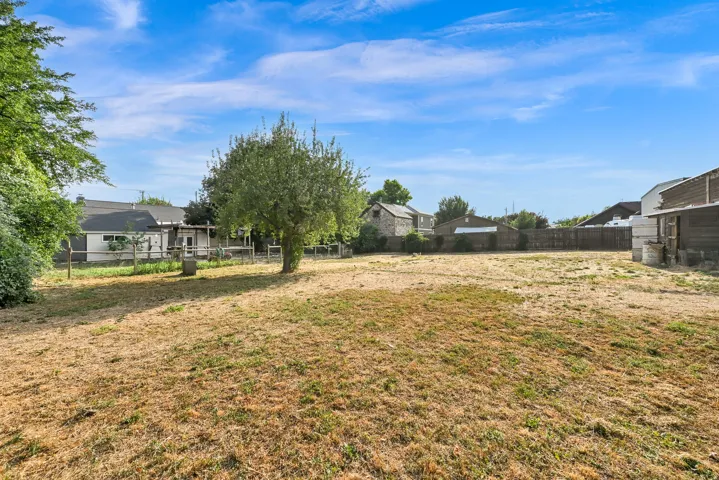 Expansive lot with established trees and partial fencing