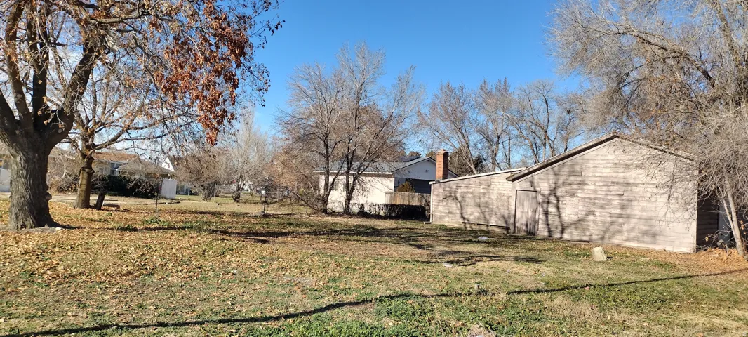Expansive lot featuring mature trees and a detached outbuilding