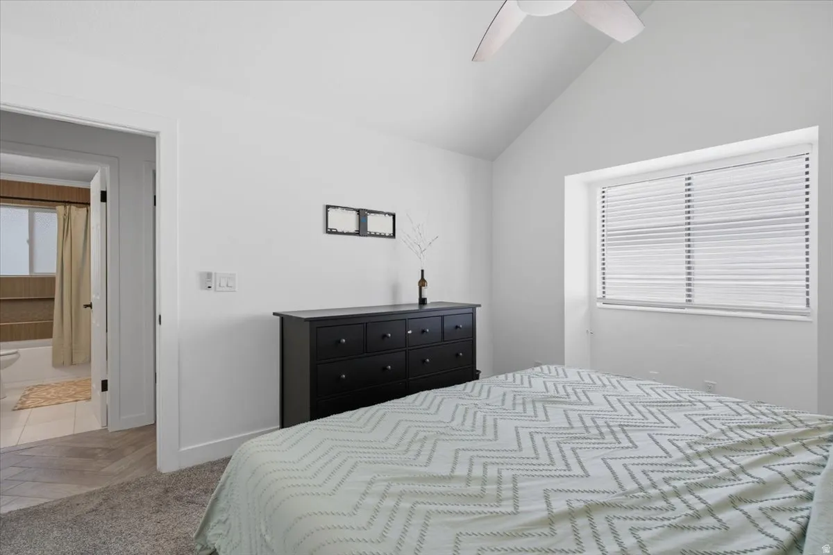 Bedroom featuring a vaulted ceiling and a ceiling fan