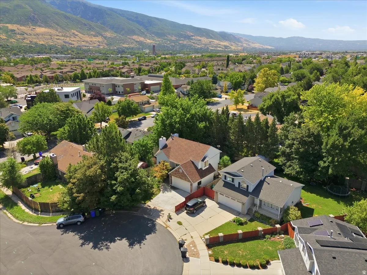 Residential neighborhood with mature trees and mountain scenery