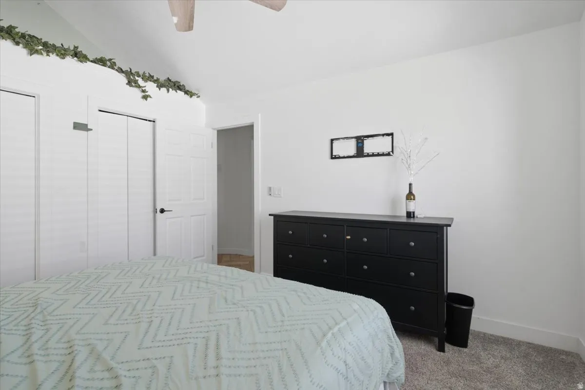 Bedroom featuring a vaulted ceiling and a ceiling fan
