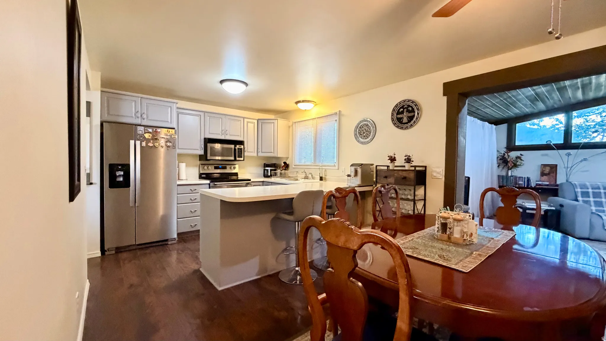 Kitchen with wood-finish flooring and light gray cabinetry