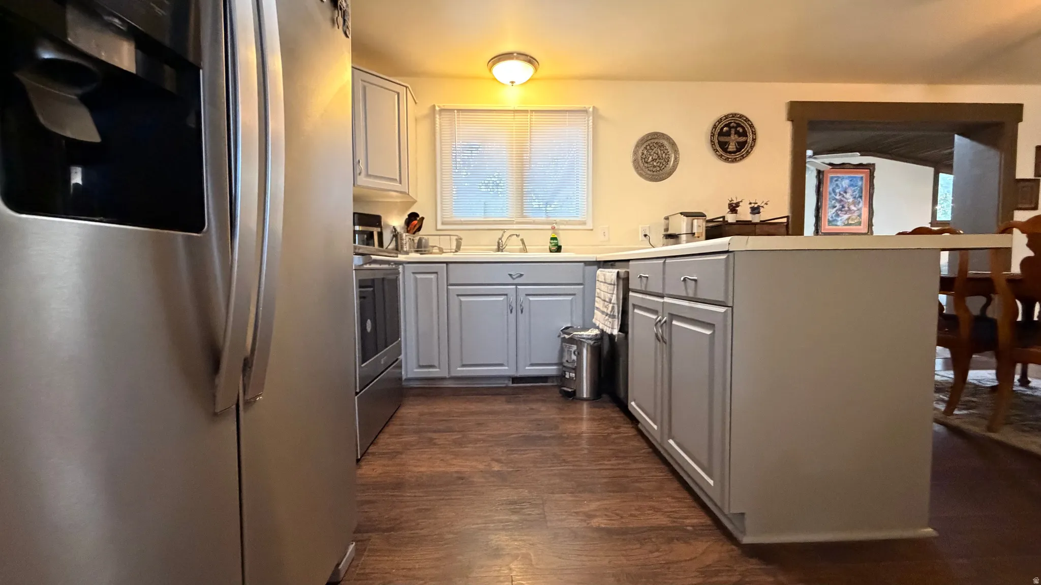 Kitchen featuring wood-finish flooring and grey cabinetry