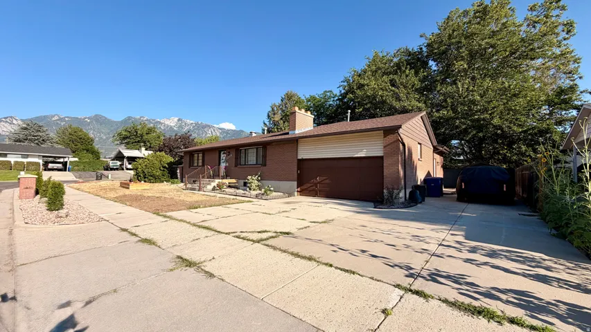 Brick exterior with a brown roof and attached garage