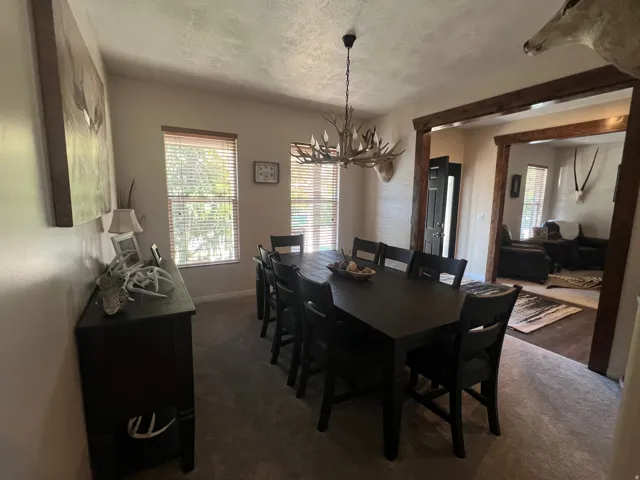 Dining area featuring a ten-seat dark wood-finish dining table and coordinating chairs