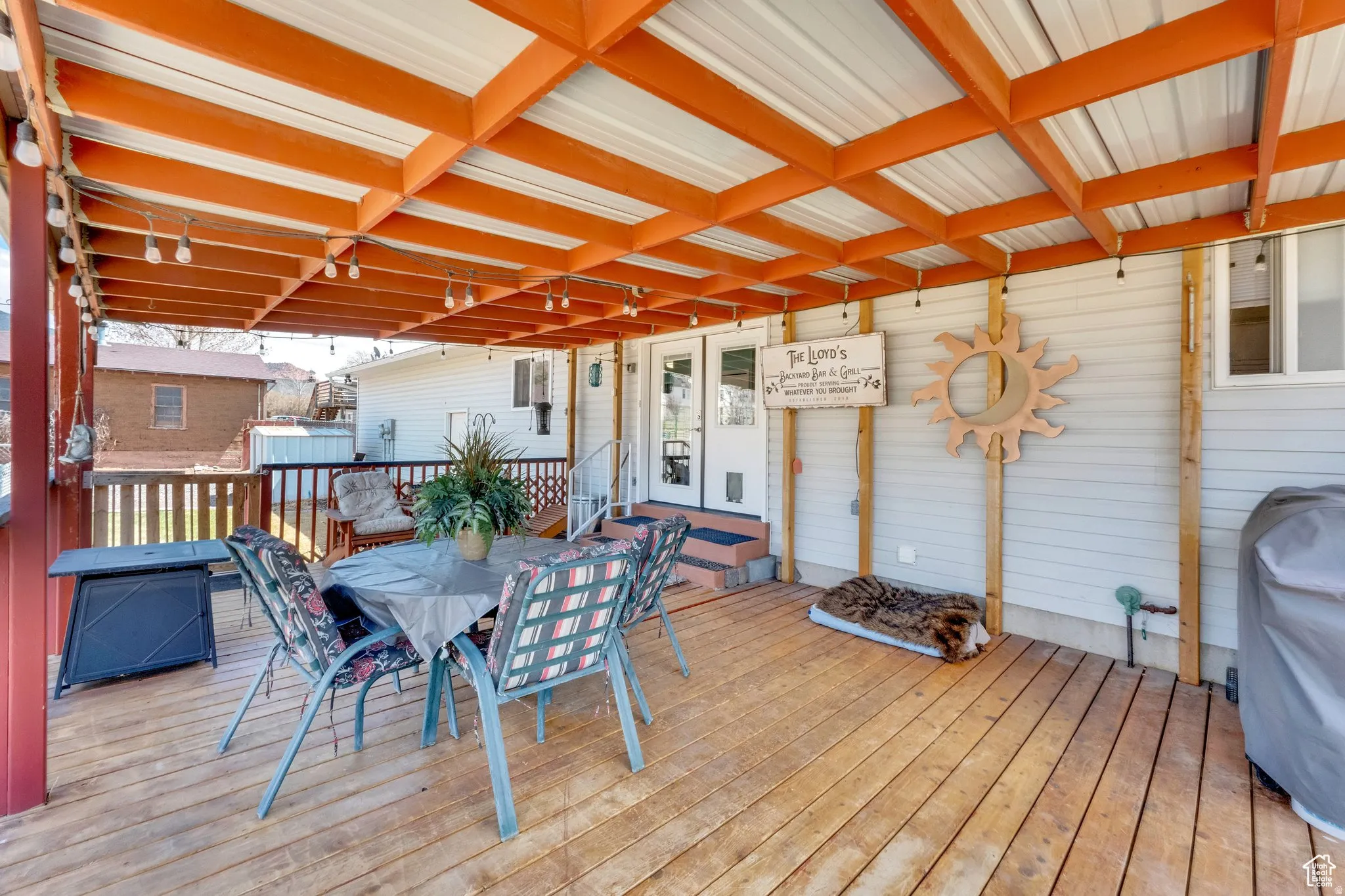 Expansive wood-finish deck with a robust wood and metal roof structure