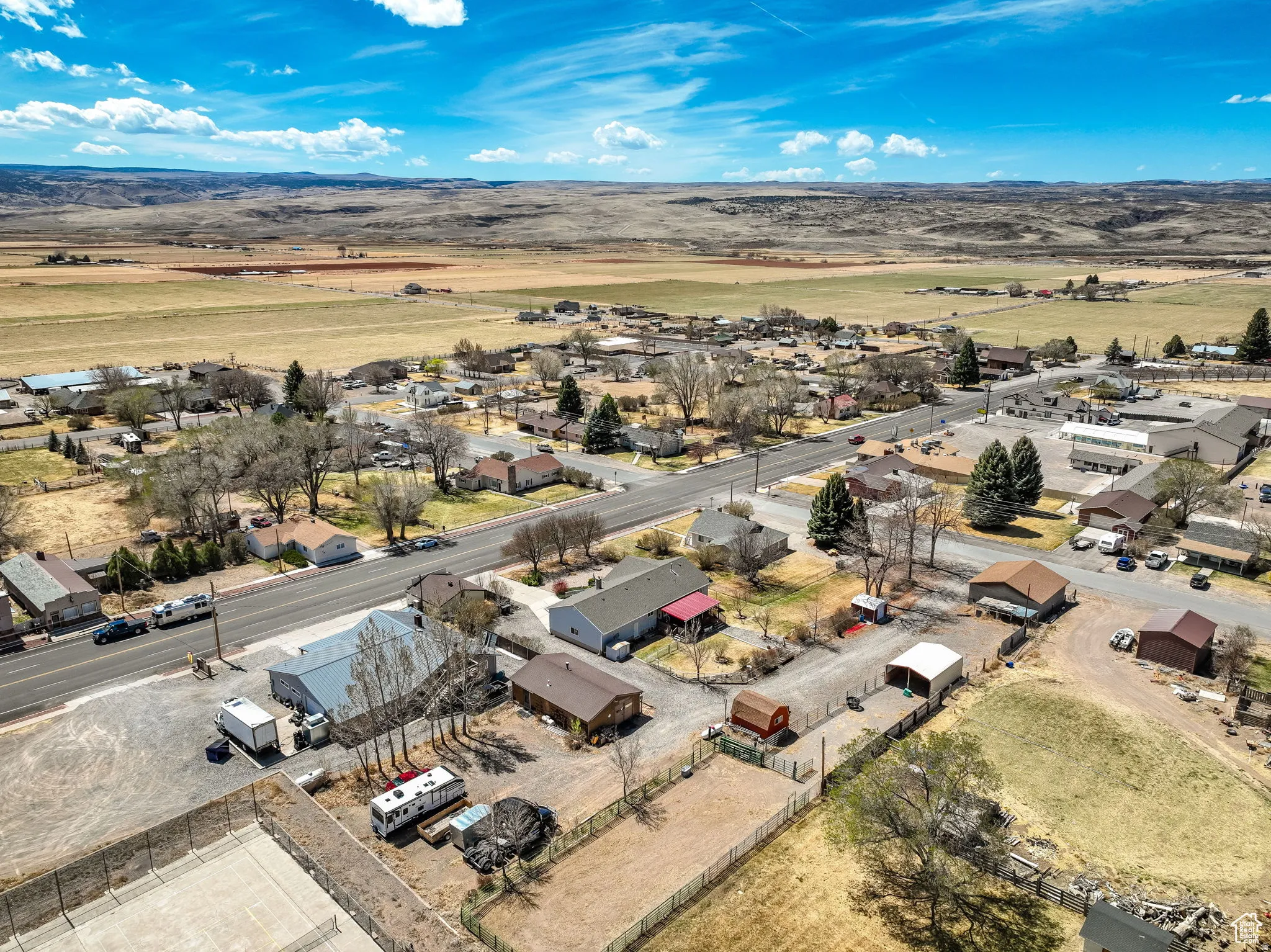 Aerial perspective showcasing a residential and commercial area with expansive surrounding landscapes